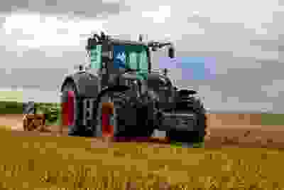 Farming machinery and tractor in a field