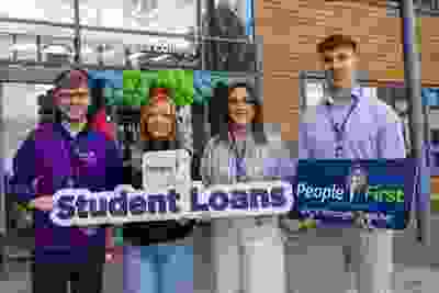 people first credit union staff holding signs for student loans outside portlaoise college